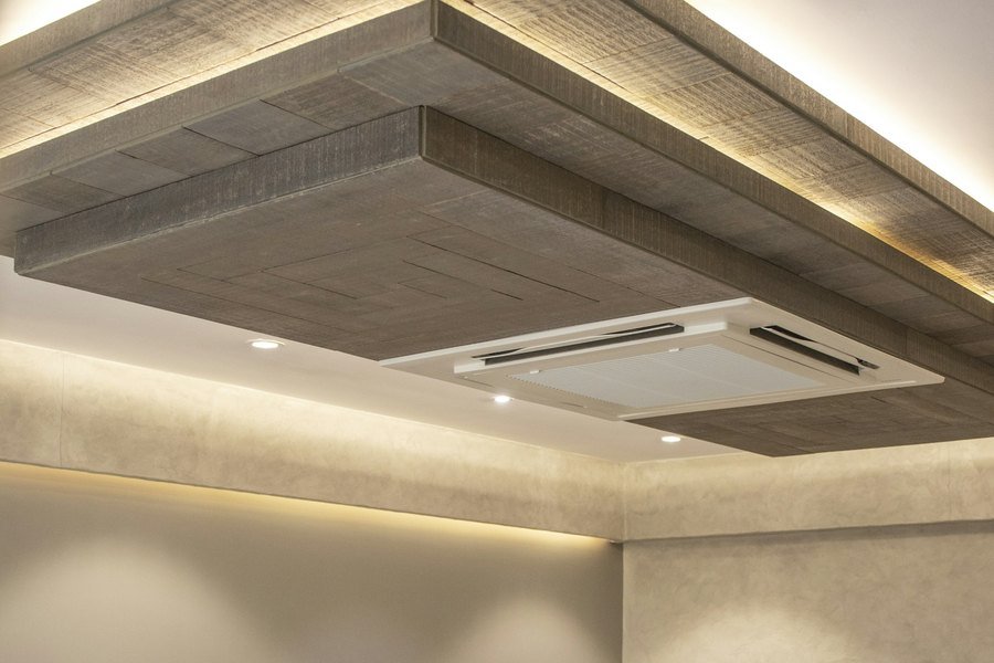 Gypsum bulkhead ceiling with concealed cove lighting, recessed spots and an integrated air diffuser