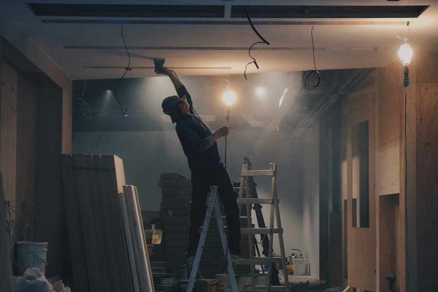 Ceiling being worked on from a ladder during a fit-out
